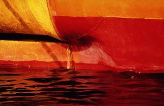 Ellen Spijkstra: '6', 2002 Color Photograph, Marine. Detail of the stern of a ship; bright red, orange and yellow, dark red reflections in the water.Laminated with a UV- protection layer. ...
