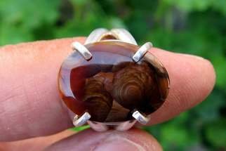 Alberto Thirion: 'mexican fire agate pendant', 2021 Jewelry, Beauty. Fire Agate Ring Size: 6. 5 US ATotal weight: 7. 1 gramsClaw adjustmentChemical Formula: Silicon dioxide - SiO2Crystal Structure: HexagonalColor: Brown with play of colorHardness: 6. 5 to 7 on the Mohs scaleRefractive Index: 1. 530 to 1. 540Density: 2. 59 to 2. ...