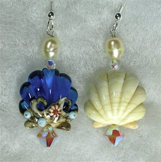 Cheryl Brumfield-knox: 'Sea Shell earrings An exercise in asymmetrical design', 2011 Jewelry, Beach. This pair of pierced earrings is a combination of highest quality, detailed, artisan lampwork beads, Swarovski Sand Opal AB crystals, sterling silver, and freshwater pearls.   Earrings are available in sterling silver French hooks with stops, or comfortable, small, silver- plated non- pierced rings that look like the real thing.  ...