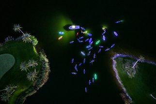 Raf Willems: 'neon paddle', 2018 Color Photograph, Abstract. Aerial Shot of people in kayaks and on paddle boards, decorated with neon.  Night shot on a lake.  High End Acrylic Print with aluminium floating frame.  Limited Edition of 100. ...