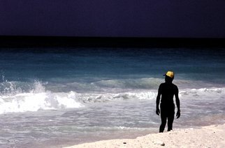Wayne King: 'The Yellow Cap', 1980 Color Photograph, Figurative.  On a beach in the Carribean a local with a yellow cap creates an interesting contrast to the blue green of the ocean.One original of this image is created, signed, dated and with a certificate of authenticity. The image is used for creation of an open edition but otherwise...