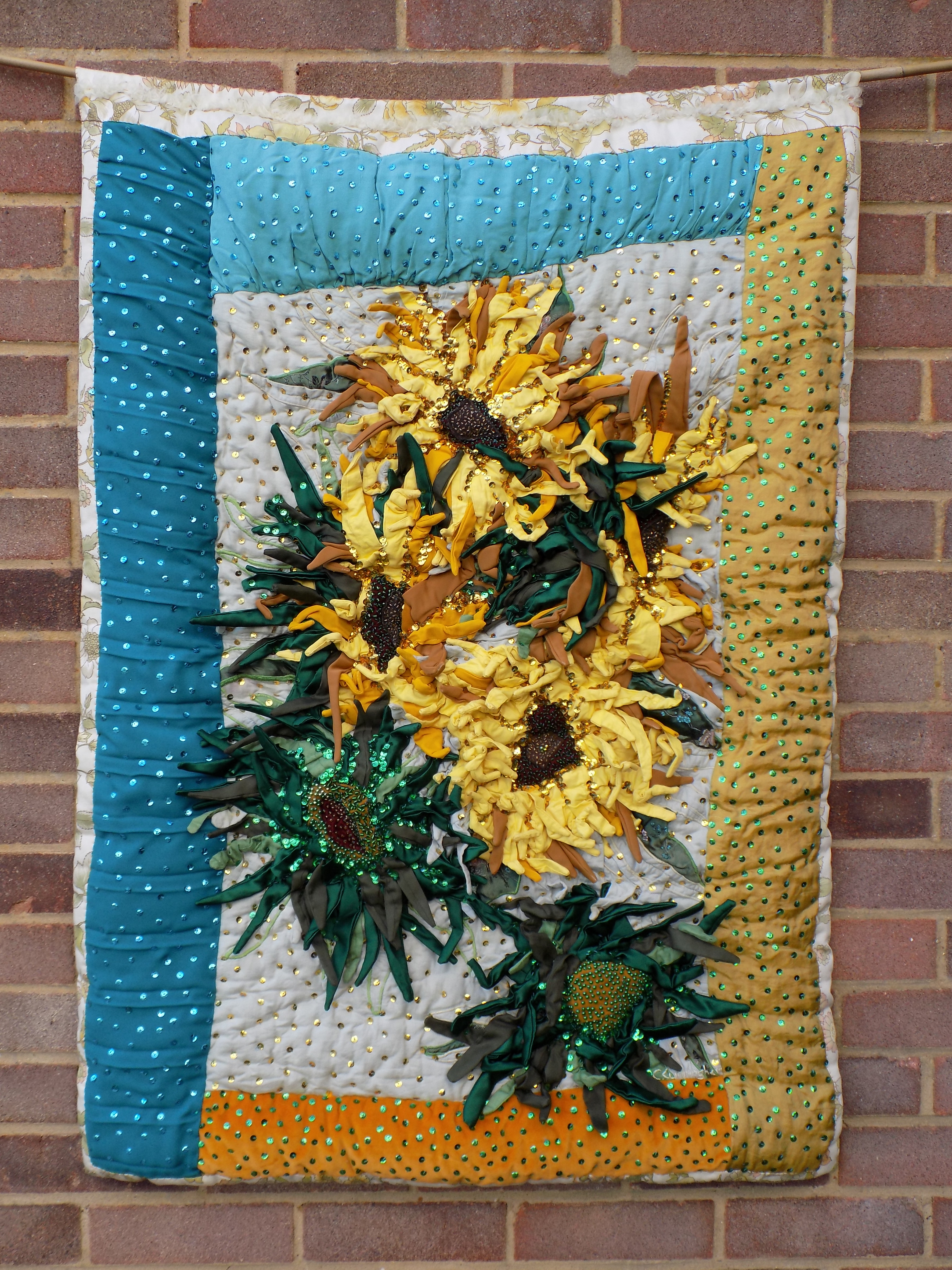 Christine Cunningham; Yellow Sunflowers, 2017, Original Textile, 33 x 47 inches. Artwork description: 241 Abstract flower design using 3D structure to create padded flower heads with individual tubular petals and leaves, with pipe cleaners giving a structured direction inside.  Embellished with beads and light reflective sequins.  Strong colour palette of yellow, gold, green and blue.  From the Abstract Flower Design 3D ...