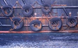 Ellen Spijkstra; 46, 2003, Original Photography Color, 41 x 27 inches. Artwork description: 241 7 Tires chained to the side of a ship.Blue- grey and rusty colors.Laminated with a clear, semi- matt, UV protection layer. ...