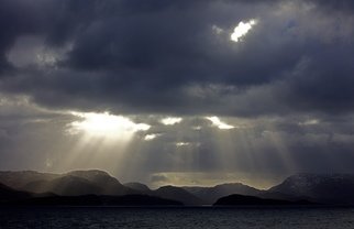 Glen Sweeney; Rays 6, 2019, Original Photography Color, 82 x 53 cm. Artwork description: 241 A shaft of sunlight illuminates the rolling Norwegian landscape of the sea and fjords. Norway, fjords, sea, winter sun. ...