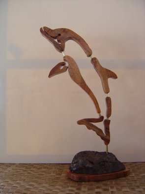Joel P Heinz Sr.; Petroglyph Dolphin, 2007, Original Sculpture Wood, 10 x 19 inches. Artwork description: 241  Petroglyph Dolphin is the artests rendering of what a petroglyph of a dolphin might be if it one existed. To date none have been found. The Dolphin is carved from pretious Hawaiian Koa wood. The baise is constructed of hawaiian Koa and lava, There petroglyphs carved into ...