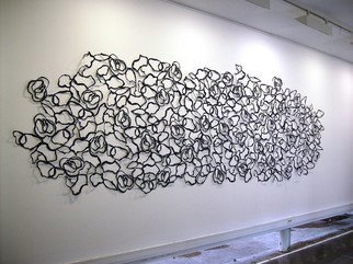 Marisa Torres; Ripples, 2013, Original Installation Indoor, 204.7 x 118.1 inches. Artwork description: 241 Ripples wants to recreate the feeling of looking at the waves formed on the wateraEURtms surface. The installation is made up of 520 paper cutout elements, pinned onto the wall. These shapes project their shadows, creating an illusion of three- dimensionality, as if the piece was ...