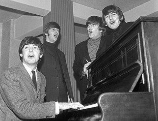 Paul Berriff; The Beatles The Chorus, 1963, Original Photography Black and White, 44 x 33 inches. Artwork description: 241  The Beatles enjoy a sing song around a piano in their dressing room at the Gaumont Theater in Bradford Yorkshire England before their Christmas concert on 21 December 1963.  This is a limited edition and is signed on the verso by photographer Paul Berriff with limited edition ...