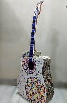 Radha  Chaudhary: 'guitar', 2019 Mosaic, Music. It s a mosaic.  I used my old wooden guitar which was not in use. . . . .  I m a music lover soo i choose to make mosaic of my old guitar.  I have used tiles to make the same. . . .  this is for all the music and guitar lovers there. . .  and obviously ...