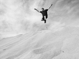 Riley Young: 'wild child', 2022 Digital Photograph, People. Digital photograph of a person jumping in the sand dunes in Death Valley National Park. ...