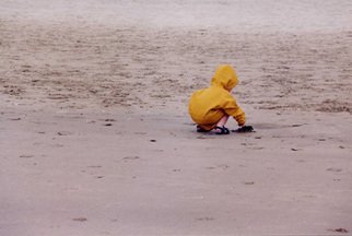 Ruth Zachary: 'Childs Play', 2004 Color Photograph, Children.  Little- one ( boy or girl seen from the back) in bright yellow slicker playing at the seaside on the sand.  Simple composition. Sweet and charming. Cannon Beach, OR.  11 x 14